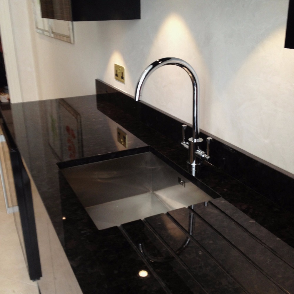 dark coloured worktop with sink and tap finshed in new silicone