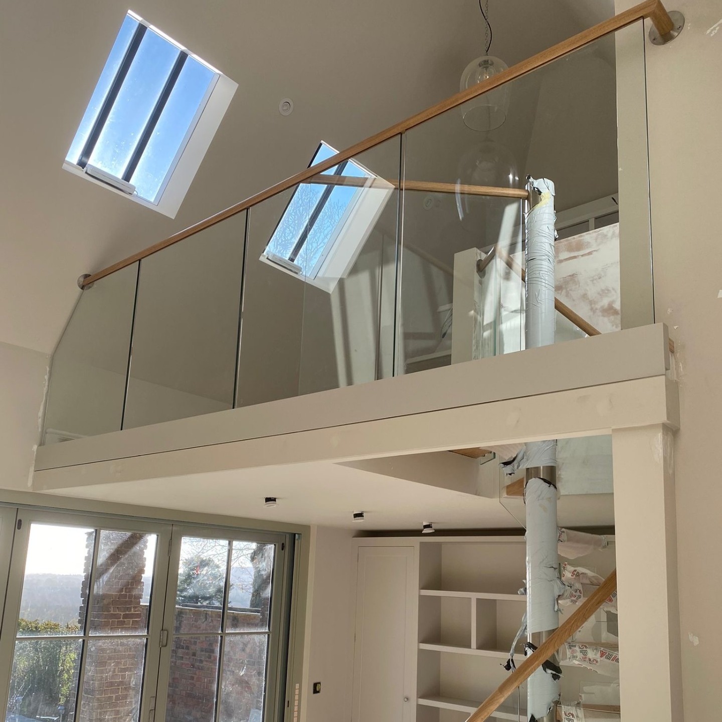 spiral stairs and mezzanine floor with velux windows