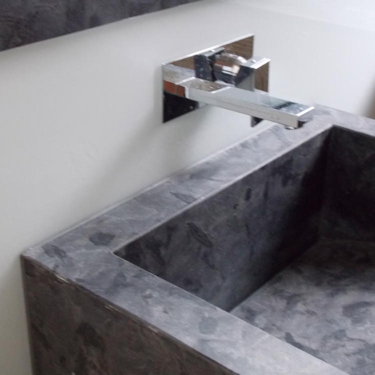 grey stone sink with matching silicone sealant