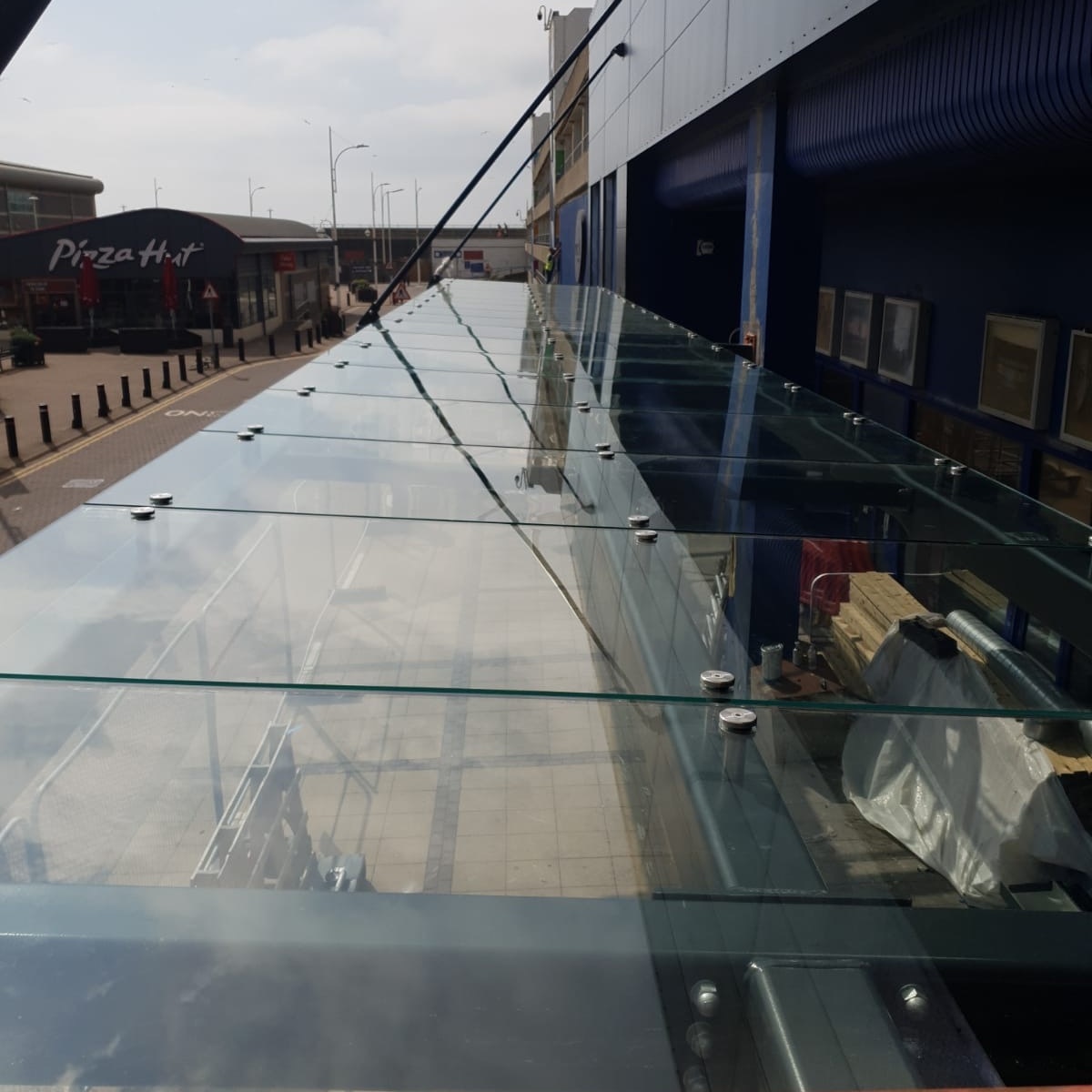 Silicone applied to gaps between sheet glass panels for a seamless finish
